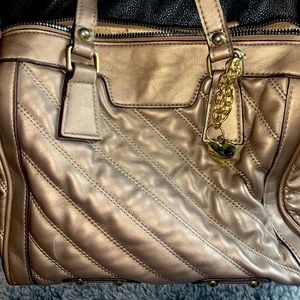 Woman’s gold Juicy Couture purse
